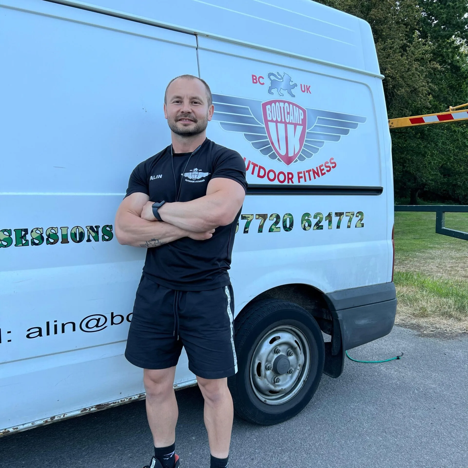 Coach Alin Suciu standing beside the Bootcamp UK van