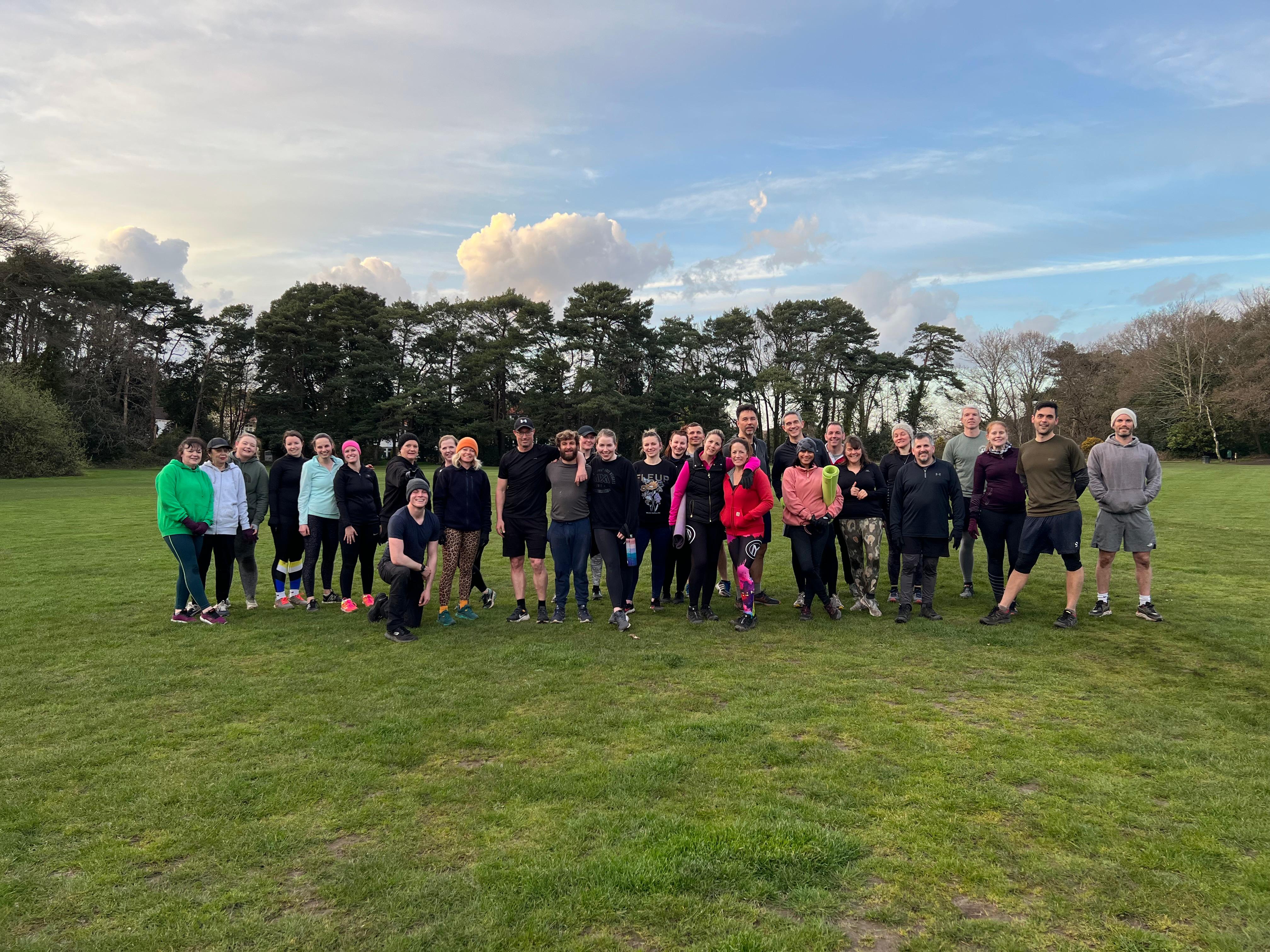 A large outdoor bootcamp group in a Bournemouth park